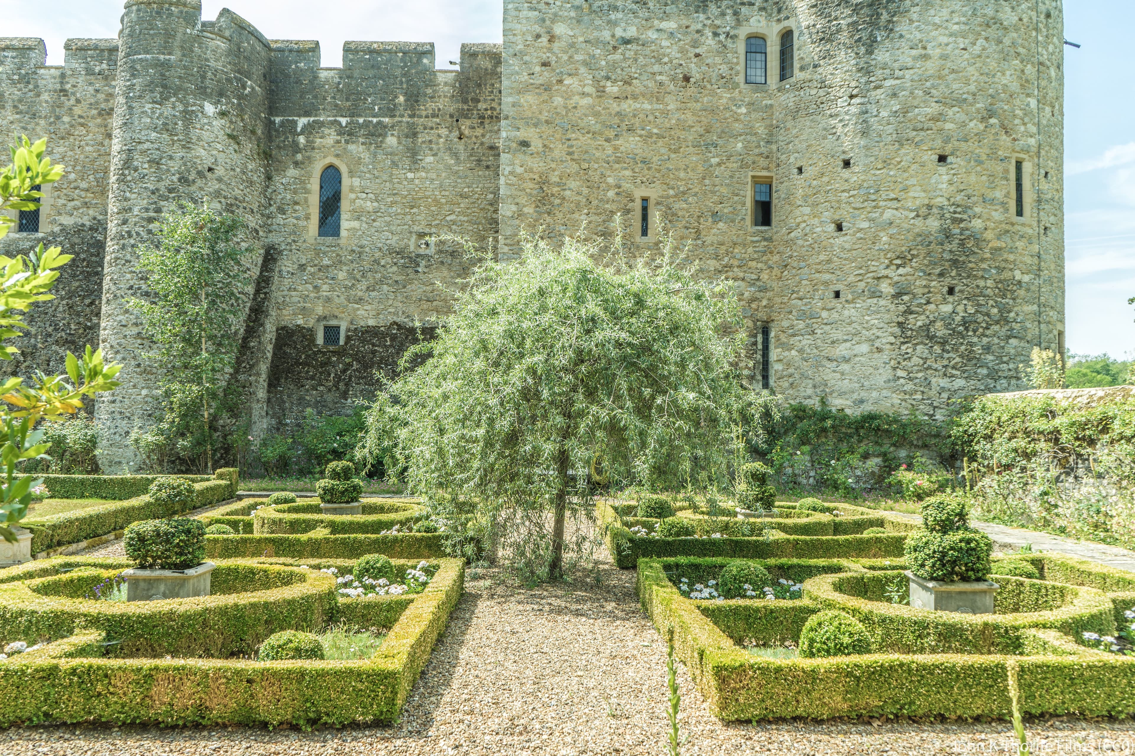 GV I The first castle on the site was a moated mound built by William de Warenne. In the C12 further building took place to the north of this, but this castle was 'overthrown' in 1174, and a small manor house built on the site. Portions of both these constructions were incorporated in the subsequent castle.
The present building was erected by Stephen de Penchester, or Penshurst, between 1279 and 1299 and continued by his son-in-law and successor Sir Henry de Cobham in the early C14. It was altered by Sir Henry Wyatt after 1492. It was forfeited to the Crown in 1554 at Sir Thomas Wyatt's rebellion. It subsequently became two farm houses and eventually fell into ruins, from which is was rescued by Lord Conway who, with his architect W.D Caröe, thoroughly restored the Castle between 1905 and 1929.
It is a square fortified country house consisting of buildings ranged round the inside of the courtyard with a curtain wall connecting them and semi-circular towers facing the moat which connects with the Medway. In the south west corner is Soloman's Tower of four storeys, which is larger than the other towers. In the northwest corner is the Gatehouse with restored machicolation and battlements, and iron-studded medieval double doors, approached by a barbican and stone bridge over the moat. The lower portions of the Gatehouse date from the C12 manor house. The wing which divides the courtyard in half was built by Sir Henry Wyatt and contained a long gallery, which was probably one of the first long galleries in England to be constructed. This was later destroyed but was restored by Lord Conway. Sir Henry Wyatt added the timber-frame buildings in the southeast corner of the Castle which were the kitchen and offices. These are of two storeys and attic, the ground and first floors being of stone with two timbered gables above, rendered and overhanging on bressumers with moulded argeboards and pendants and one gabled dormer. Casement windows with small square leaded panes.
Sir Henry Wyatt also altered most of the windows of the Castle. His son Sir Thomas Wyatt, the poet, was born here in 1503. The latter's son, Sir Thomas Wyatt, also lived here till his insurrection in 1554. Henry VII visited the Castle in Sir Henry Wyatt's time; Henry VIII in 1527, 1530 and 1536; also Cardinal Wolsey in 1527 and Catherine Parr in 1544.