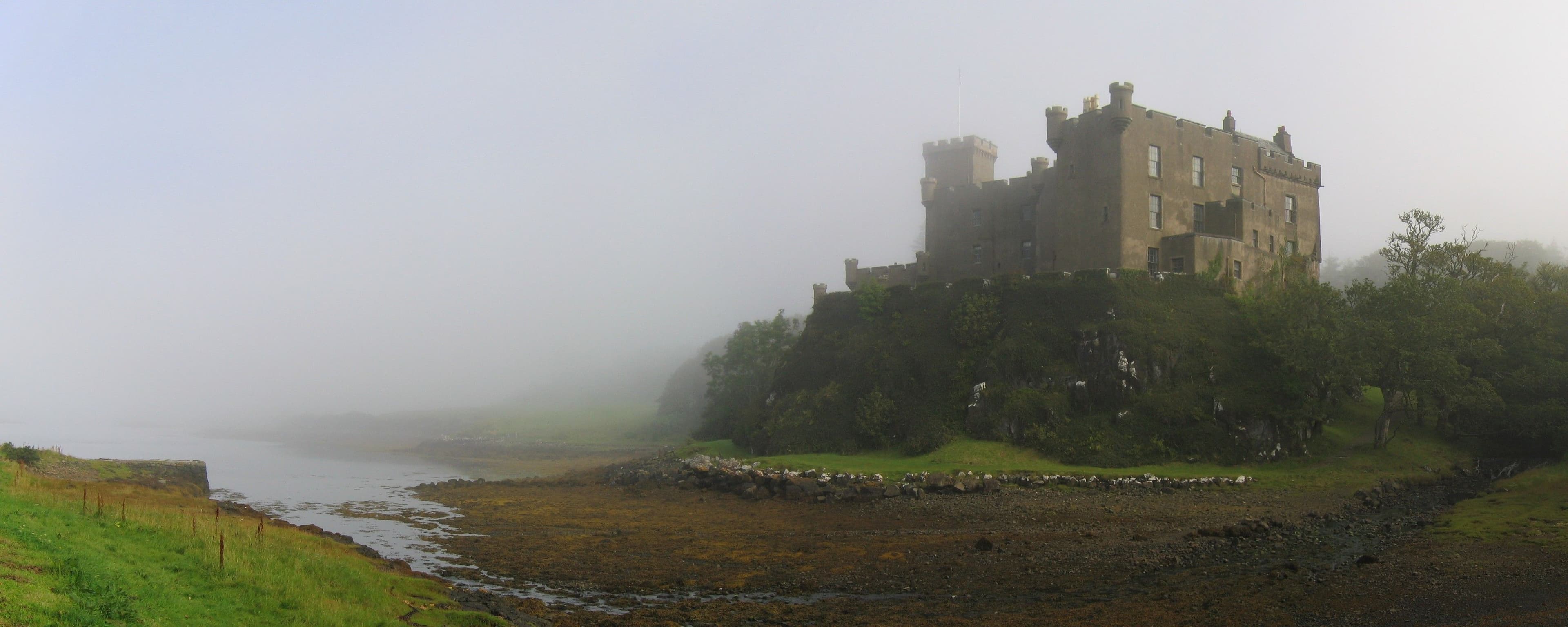 Dunvegan Castle on the Isle of Skye in the mist. Panoramic image made from own photos using hugin and enblend. Enblend-cloned some sky in the top left corner.
