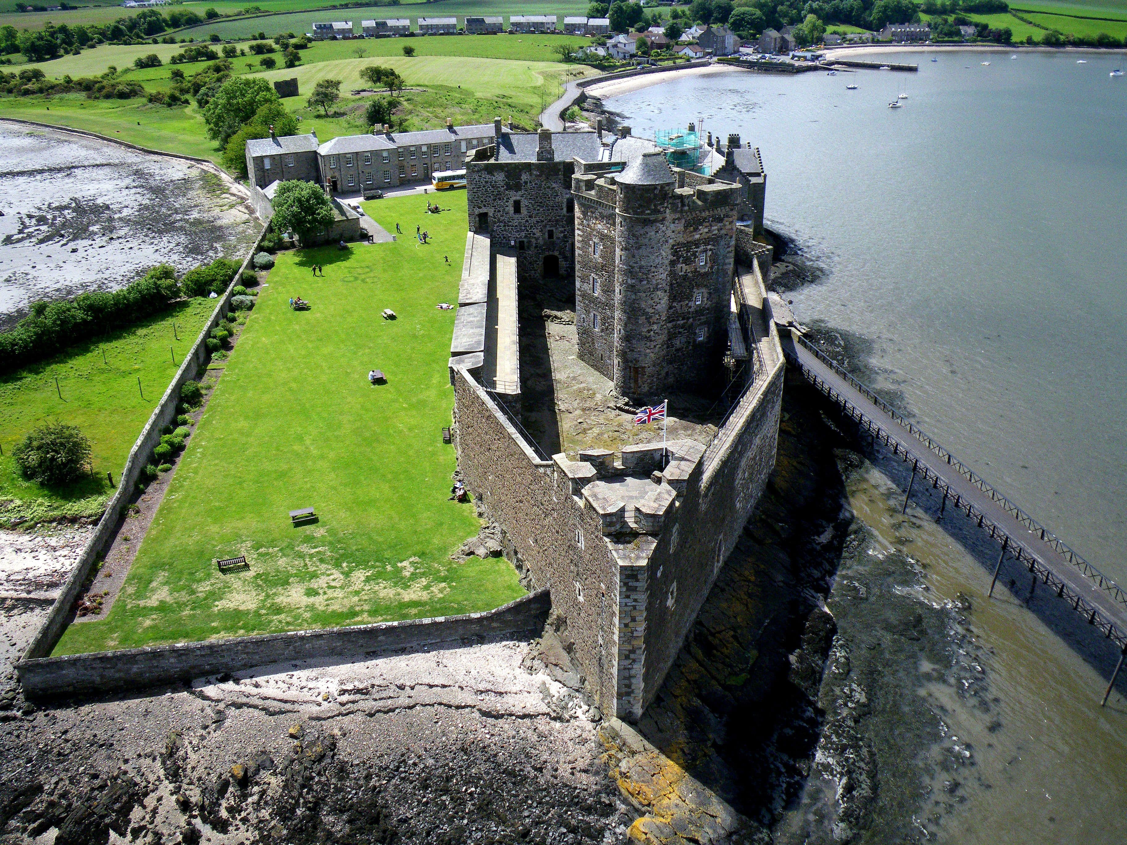 Kite aerial photo of Blackness Castle, Blackness, Scotland. The castle was built in the 1440s on a promontory projecting north into the Firth of Forth.